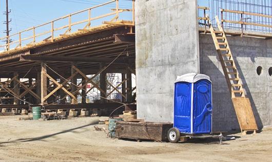 the convenience of on-site restrooms a construction site lined with portable toilets